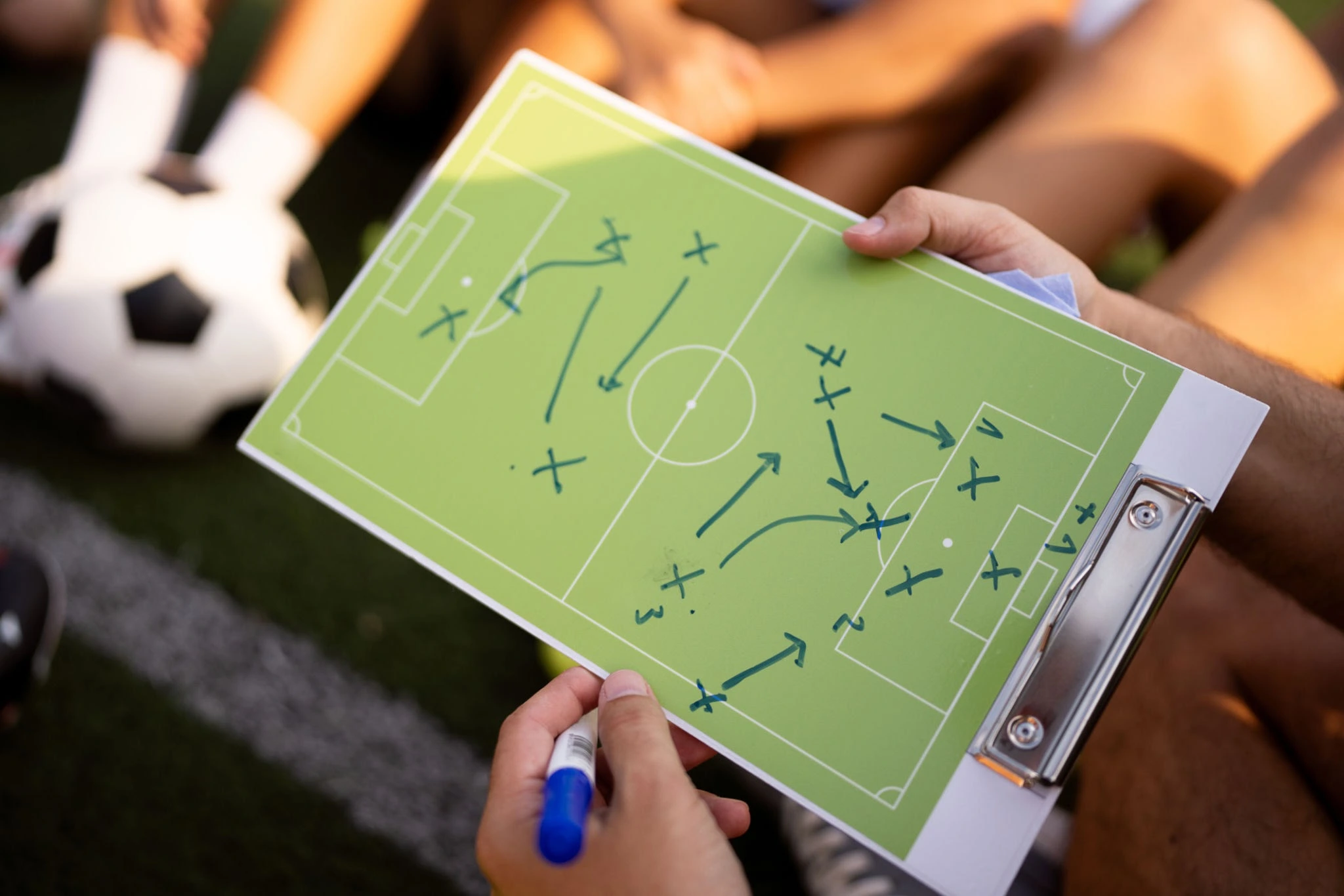 Soccer coach explaining strategy and positioning on a tactical board